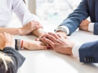 group-businesspeople-stacking-each-other-s-hand-white-desk_1024x682.jpg